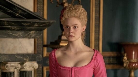 Elle Fanning wearing a pink gown starring as Catherine the Great in The Great