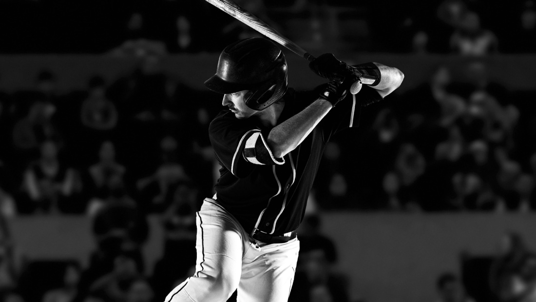 Baseball player swinging a baseball bat.