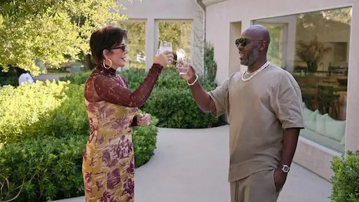 Still image from The Kardashians S1 Episode 101 ‘Burn Them All to the F*cking Ground’ featuring Kris Jenner and boyfriend Corey Gamble clinking glasses